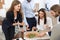 Office employees having pizza for lunch at workplace