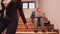 Office executive sitting on stair typing on laptop