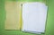 Office folder paper sheets pencil on green background