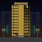 Office high-rise building at night on the background of residential buildings with trees and lanterns brightly illuminating the st