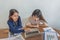 Office ladies having business financial discussion and using laptop