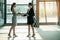 Office ladies shaking hands indoor.