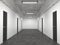 Office lobby with many identical closed black doors and an empty white wall. Corridor interior in loft style. 3D rendering with