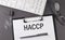 Office paper sheet with text HACCP and keyboard. Business concept