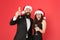 Office party. Couple at corporate party. Happy new year. Bearded businessman in tuxedo and girl elegant dress drinking