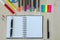 Office supplies laying on a wooden desk background.Top view. Pencils,scissors,markers,stickers,bookmarks,glasses