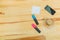 Office table with accessories: a white sheet of paper, a marker of blue and pink, a telephone, a cup of coffee. In order