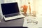 Office table with blank screen on laptop, bottle of water, beaut