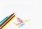 Office utensils supplies concepts, colorful pencils and clips on white background
