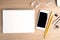 Office wooden desk table with smartphone. Top view with copy space.