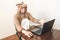 Office worker in cosplay costume of a cow. Guy in the funny animal pyjamas sleepwear near the laptop. Parody on manager