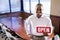 Office worker holding open sign in empty boardroom