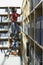 Office Worker On Ladder In File Storage Room