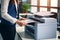 Office worker print paper on multifunction laser printer. Document and paperwork. Secretary work. Woman working in business office