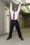 Office worker stretching in corridor