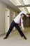 Office worker stretching in corridor