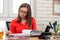 An office worker turns over documents in a folder and reads them carefully