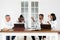 Office workers gather around a table to do research and implement new ideas