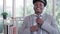 In the office, a young black African man pilot wears a cap