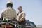 Officer Looking At Coworker Sitting On Motorbike