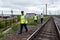 Officers of departmental security with a police officer bypass the section of the railway.