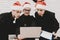 Officers In A Santa Claus Caps Staring On Laptop.