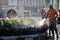 Officers Surakarta local government sanitation departments take care of the city park with a hose with water each morning.