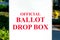 Official ballot drop box sign on white collection box set up outdoor during election