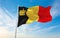 official flag of Belgium yacht ensign , Belgium at cloudy sky background on sunset, panoramic view. Belgian travel and patriot