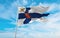 official flag of commander of the Finnish Defence Forces, Finland at cloudy sky background on sunset, panoramic view. Finnish