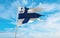 official flag of Pennant of Commander of Naval Command, Finland at cloudy sky background on sunset, panoramic view. Finnish travel