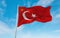 official flag of President of Turkey Turkey at cloudy sky background on sunset, panoramic view. Turkish travel and patriot concept