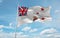 official flag of Queen\\\'s Colour for Royal Navy New Zealand at cloudy sky background on sunset, panoramic view. New