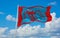 official flag of Spetses Greece at cloudy sky background on sunset, panoramic view. Greek travel and patriot concept. copy space