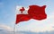 official flag of Tonga at cloudy sky background on sunset, panoramic view. patriot and travel concept. copy space for wide banner