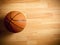 An official orange ball on a basketball court