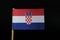 A official and unique flag of Croatia on toothpick on black background. A horizontal tricolour of red, white, and blue with the