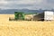 Offloading harvested wheat from a combine to a truck