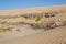 Offroad camping at Kunene River in front of towering ancient Namib Desert sand dunes of Namibia and Angola