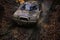 Offroad car going through deep mud holes