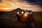 Offroad car on mountain road at sunset