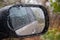 Offroad car window with side mirror in autumn bad weather