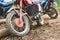 Offroad mountain motorcycles or bikes taking part in motocros competition parked on dirty terrain road