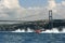 Offshore boats racing under the Bosphorus Bridge in Istanbul, Turkey