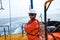 Offshore engineer, standing on the deck of an industrial ship