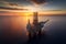 Offshore jack-up rig in the middle of the sea at sunset, capturing the serene beauty of the ocean. Generative AI