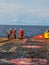 Offshore marine crew working on deck during sunny day