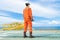 An offshore oil rig worker wearing personal protective equipment and standing on offshore wellhead remote platform