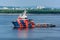 Offshore tug/Supply ship passes underway along the Singapore island shoreline