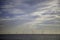 Offshore wind farm on horizon with calm sea